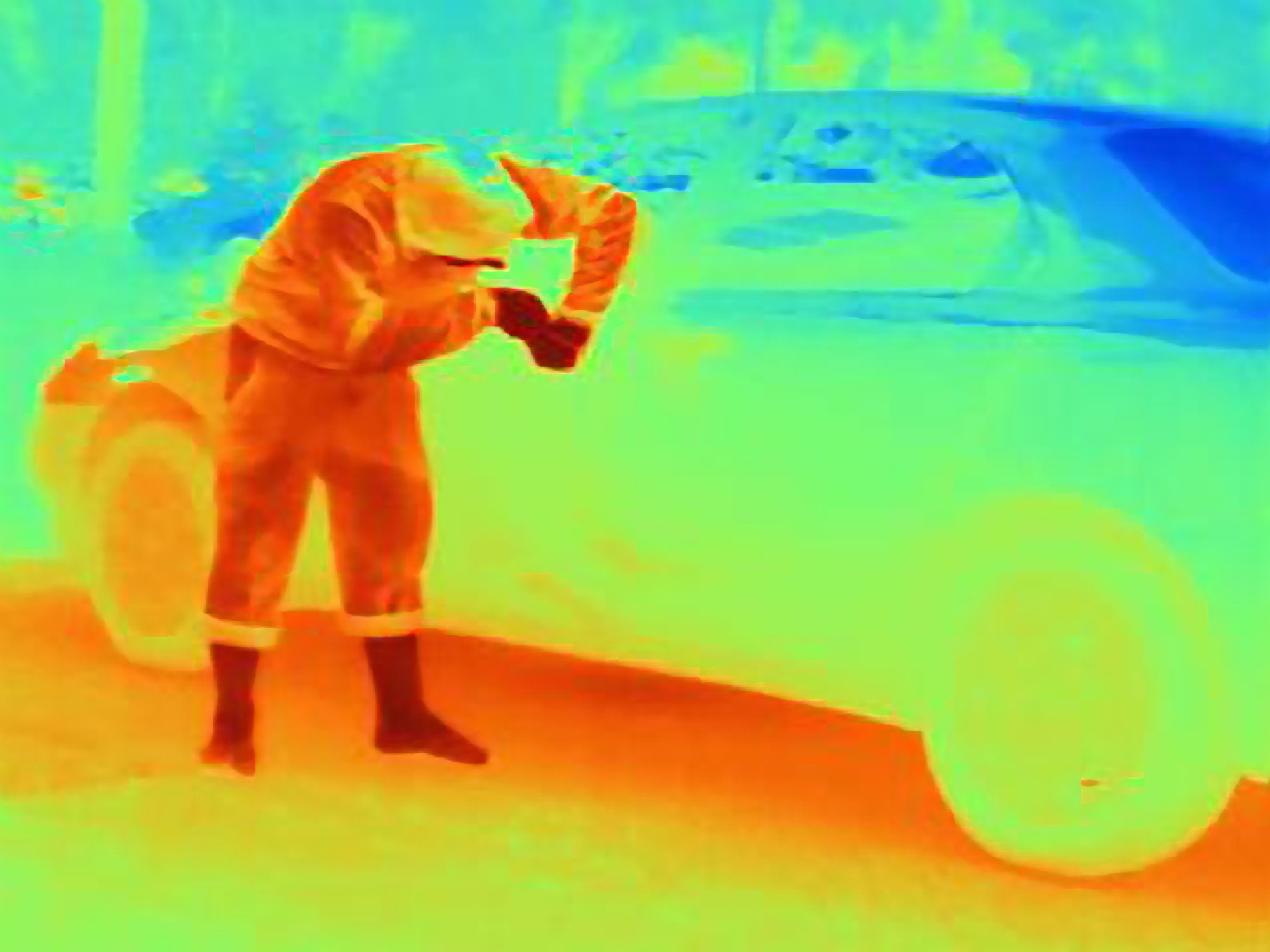 Thermal photograph of a burglar breaking into a car